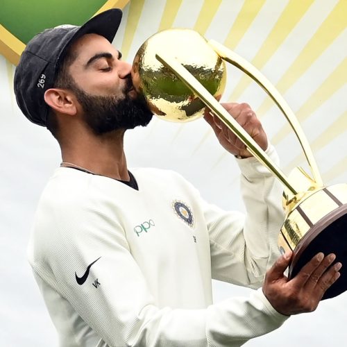 TOPSHOT - India's captain Virat Kohli kisses the Border-Gavaskar trophy as the Indian team celebrates their series win on the fifth day of the fourth and final cricket Test against Australia at the Sydney Cricket Ground in Sydney on January 7, 2019. (Photo by PETER PARKS / AFP) / -- IMAGE RESTRICTED TO EDITORIAL USE - STRICTLY NO COMMERCIAL USE --        (Photo credit should read PETER PARKS/AFP via Getty Images)