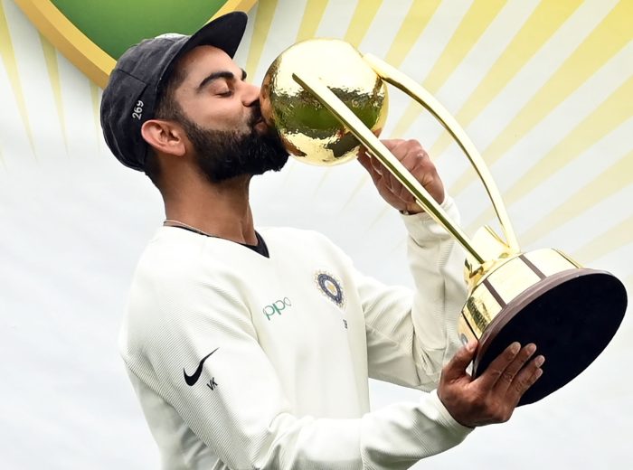 TOPSHOT - India's captain Virat Kohli kisses the Border-Gavaskar trophy as the Indian team celebrates their series win on the fifth day of the fourth and final cricket Test against Australia at the Sydney Cricket Ground in Sydney on January 7, 2019. (Photo by PETER PARKS / AFP) / -- IMAGE RESTRICTED TO EDITORIAL USE - STRICTLY NO COMMERCIAL USE --        (Photo credit should read PETER PARKS/AFP via Getty Images)